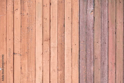 Wooden boards on an old red fence as an abstract background.