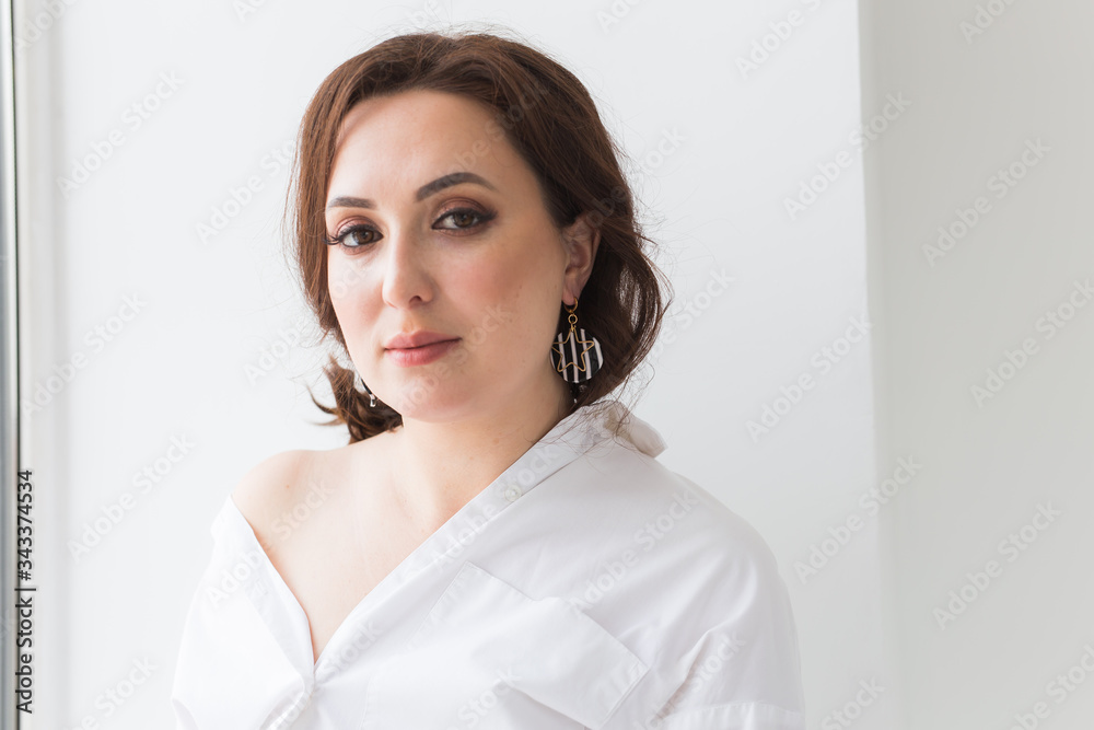 Elegant woman with earrings, close up portrait. Accessories, jewelry and bijouterie concept. Elegant woman with earrings, close up portrait. Accessories, jewelry and bijouterie concept.