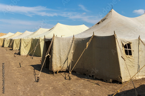 Photography Group of canvas military tents in a sunny field