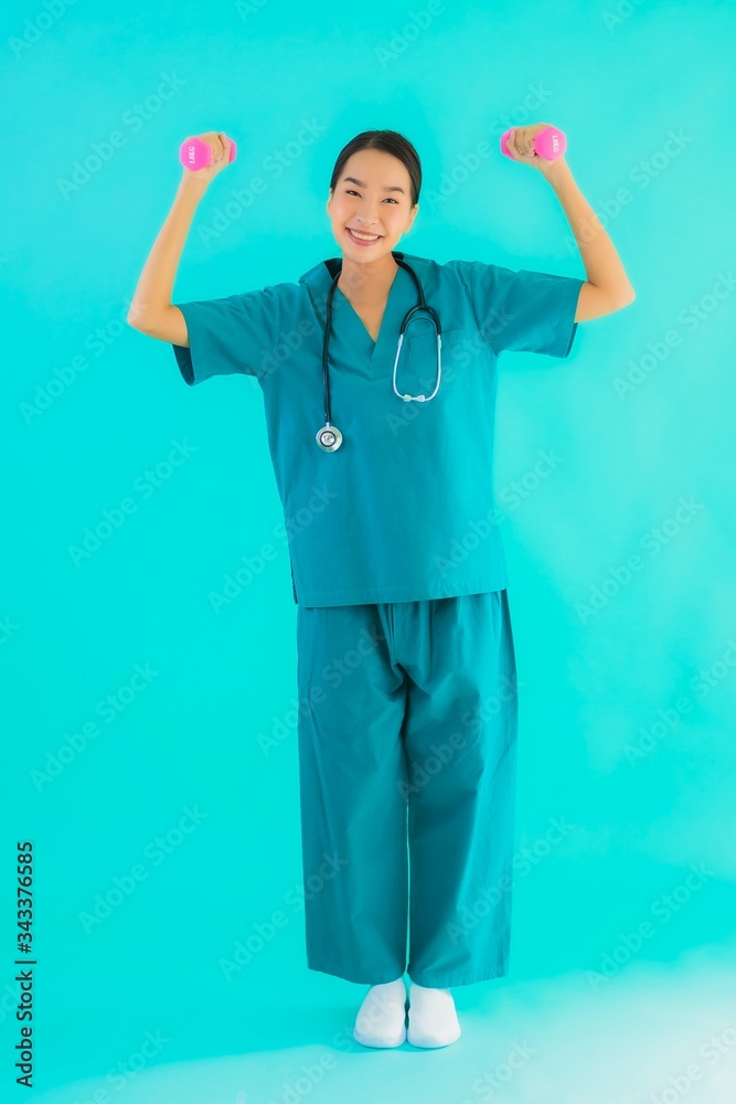 Portrait beautiful young asian doctor woman exercise with dumbbell Portrait beautiful young asian doctor woman exercise with dumbbell