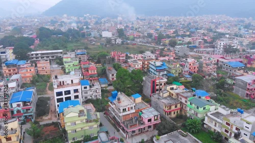 Revealing housing settlements in a small developing city Hetauda Town, Makwanpur, Nepal. Drone aerial shot looking up. photo