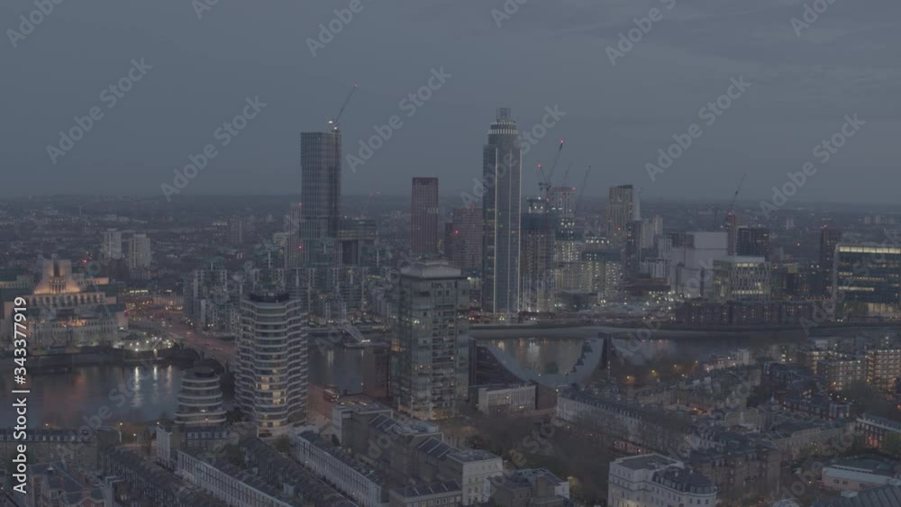 Bright, vibrant London City Center aerial drone shot over River Thames and office buildings. Dusk, night time with illuminations. Needs colour grading. Busy city Bright, vibrant London City Center aerial drone shot over River Thames and office buildings. Dusk, night time with illuminations. Needs colour grading. Busy city