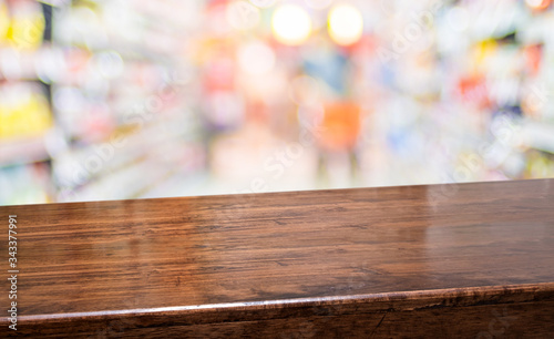 wood diagonal table with people shopping food at supermarket blur background.Mock up  banner for display of product at grocery bokeh backdrop