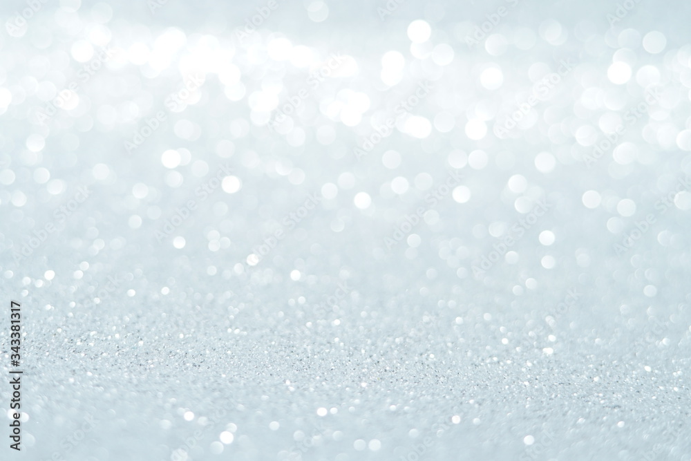 Silver Sparkling Lights Festive background with texture. Abstract Christmas twinkled bright bokeh defocused and Falling stars. Winter Card or invitation Silver Sparkling Lights Festive background with texture. Abstract Christmas twinkled bright bokeh defocused and Falling stars. Winter Card or invitation