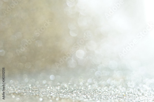 Silver Sparkling Lights Festive background with texture. Abstract Christmas twinkled bright bokeh defocused and Falling stars. Winter Card or invitation 