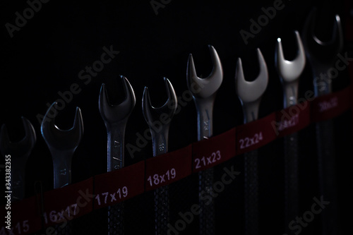 spanners in dark, creative industrial background, set of different size wrenches