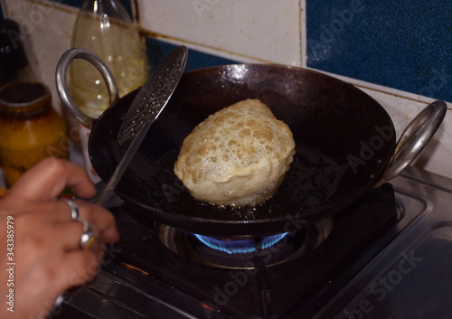 Frying Traditional Bengali Luchi ( deep fried bread) photo