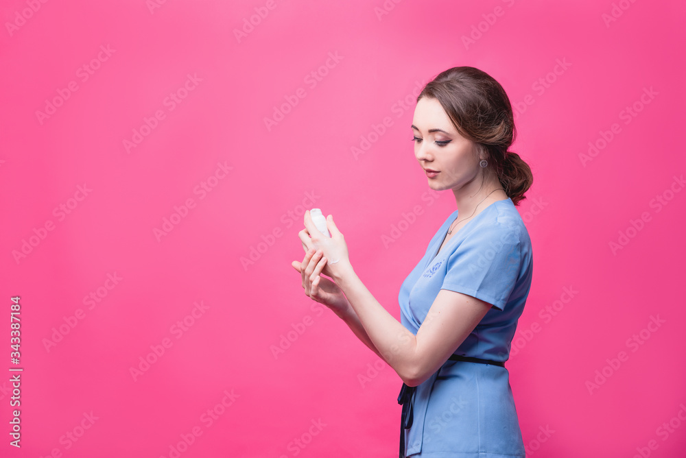 Women's hands with pink manicure applying cream. The concept of skin care. Women's hands with pink manicure applying cream. The concept of skin care.