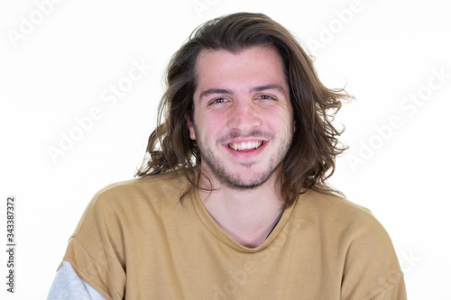 Smiling bearded long haired young man model casual attire isolated over white background