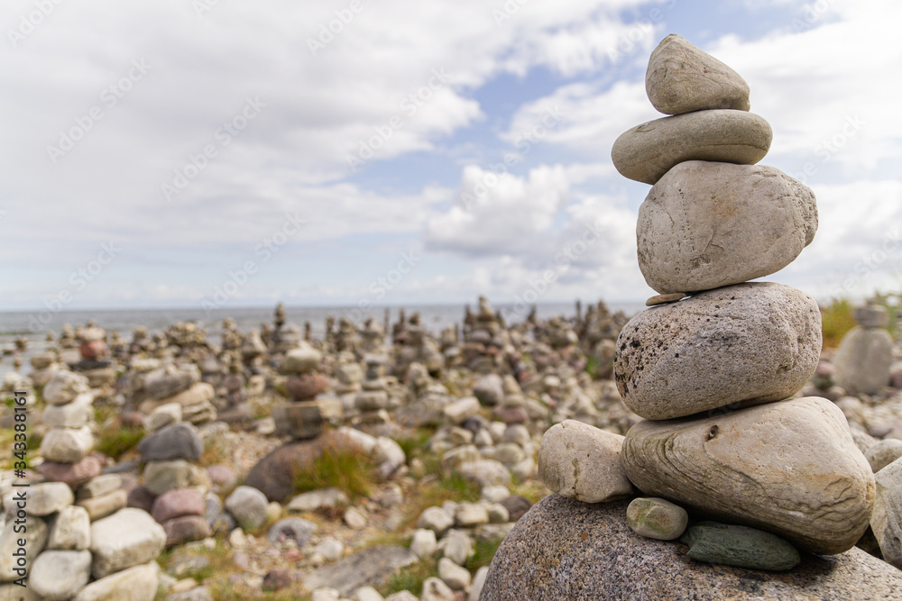 Smooth grey and white stones on each other on the beach Smooth grey and white stones on each other on the beach