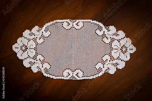 lace hand-knitted. lace tablecloth. Patterns knitted with lace crochet. Lace hand-knitted on wooden table.