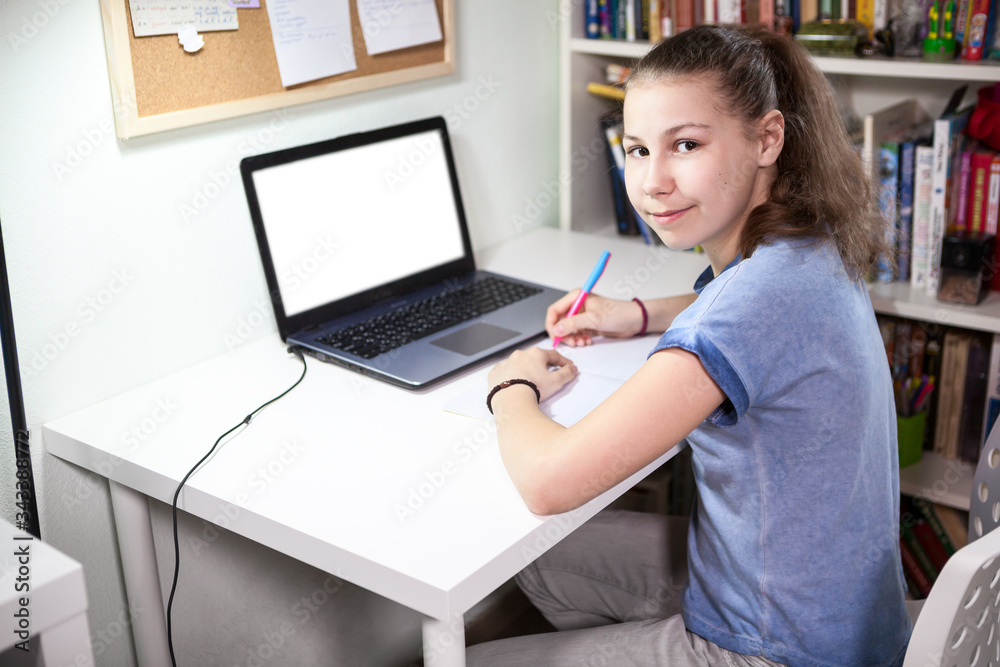 Cute schoolgirl is on distance aducation at home, homeschooling with laptop, isolated monitor screen