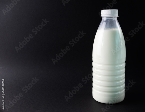 Bottle of milk on a black background. 