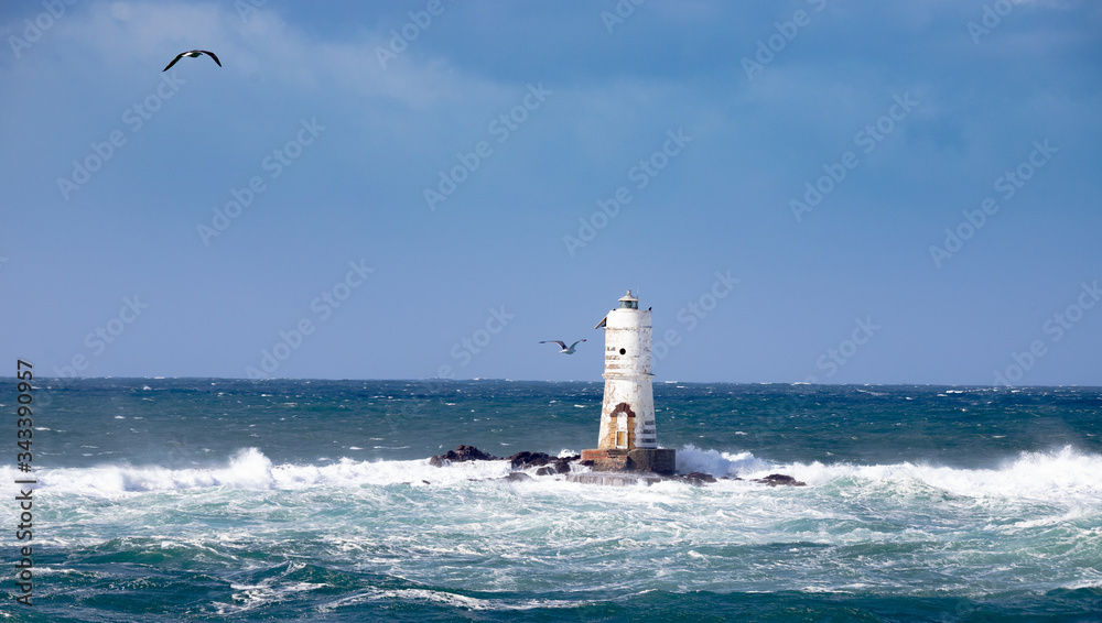 The lighthouse of the boat-eater shrouded by the waves of a mistral wind storm