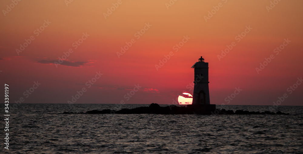  The Mangiabarche lighthouse wrapped in the waves of a mistral wind storm in a beautiful sunset