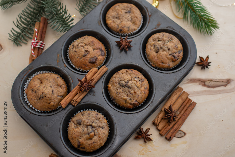 fresh chocolate muffins in muffin tin on wooden surface fresh chocolate muffins in muffin tin on wooden surface