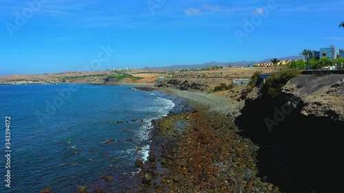 Wallpaper Mural Breathtaking aerial view of the Gran Canaria Maspalomas and the ocean. View from above. Flying over rocky seashore with seagulls, birds flying, beautiful landscape. Torontodigital.ca