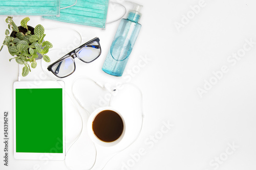 work from home work space office desk table top header layout side left relax break work in company drinking coffee cup play tablet listen music by earphone green screen at home in virus covid-19