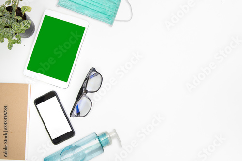 work from home office desk table top header layout work space side left place gadget technolgy smart phone, tablet and glasses for looking display isolated green screen at home in virus covid-19