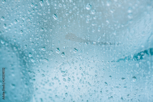 Raindrops on a car window. Rainy weather  sudden rain on the road.