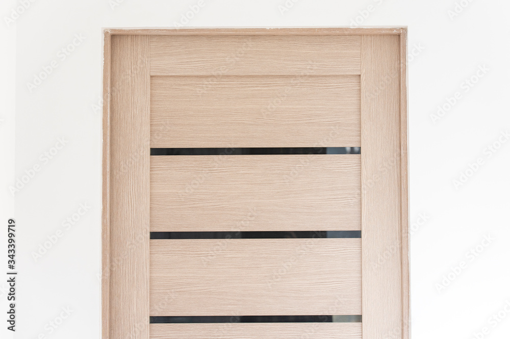 Close-up part of modern wooden door in living room, interior Close-up part of modern wooden door in living room, interior