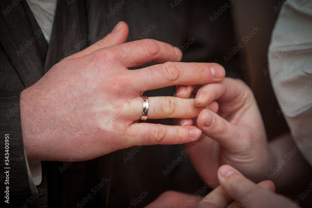 An unrecognizable bride and groom exchanging of the Wedding Rings in church during the christian wedding ceremony 