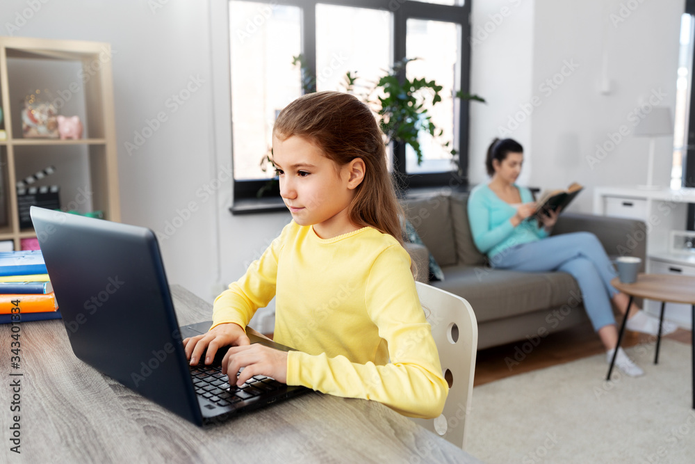 Naklejka premium children, education and distant learning concept - student girl with laptop computer and mother reading book at home
