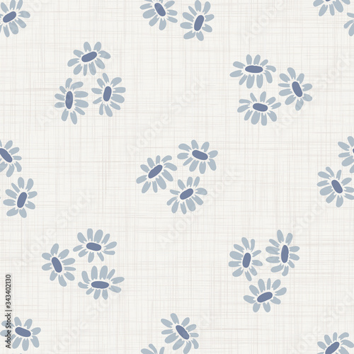 

Seamless tossed floral pattern in french blue linen shabby chic style. Hand drawn country bloom texture. Rustic woven background. Kitchen towel home decor swatch. Simple flower motif all over print
