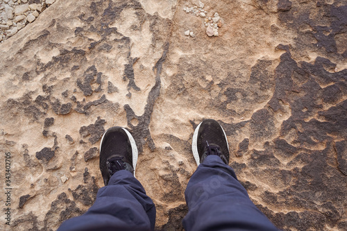 legs of man stepping on characteristic stone of Al-Habala canyon