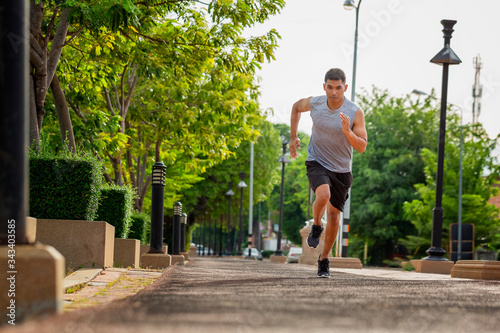 Portrait of handsome man running in the park in early morning. Healthy concept