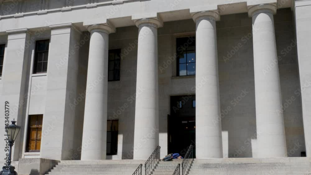 Homeless man sleeps on the steps of State of Ohio Capital Building Homeless man sleeps on the steps of State of Ohio Capital Building