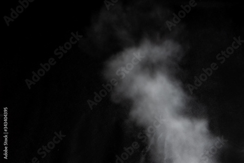 White clouds of smoke vapor isolated on a black background. The magic effect of foggy dust