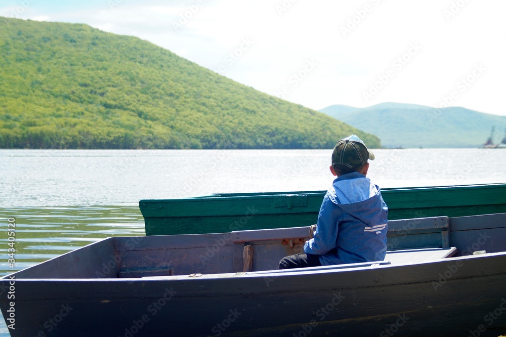 boy in a boat by the sea