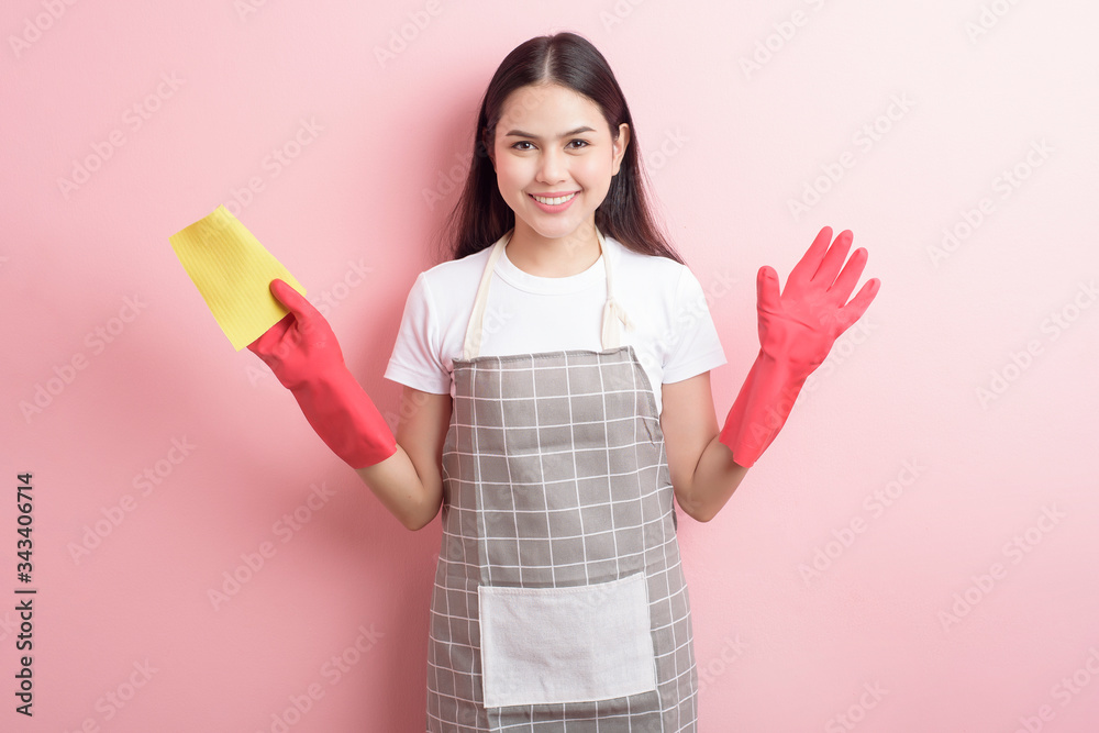 Beautiful woman housekeeper portrait on pink background Beautiful woman housekeeper portrait on pink background