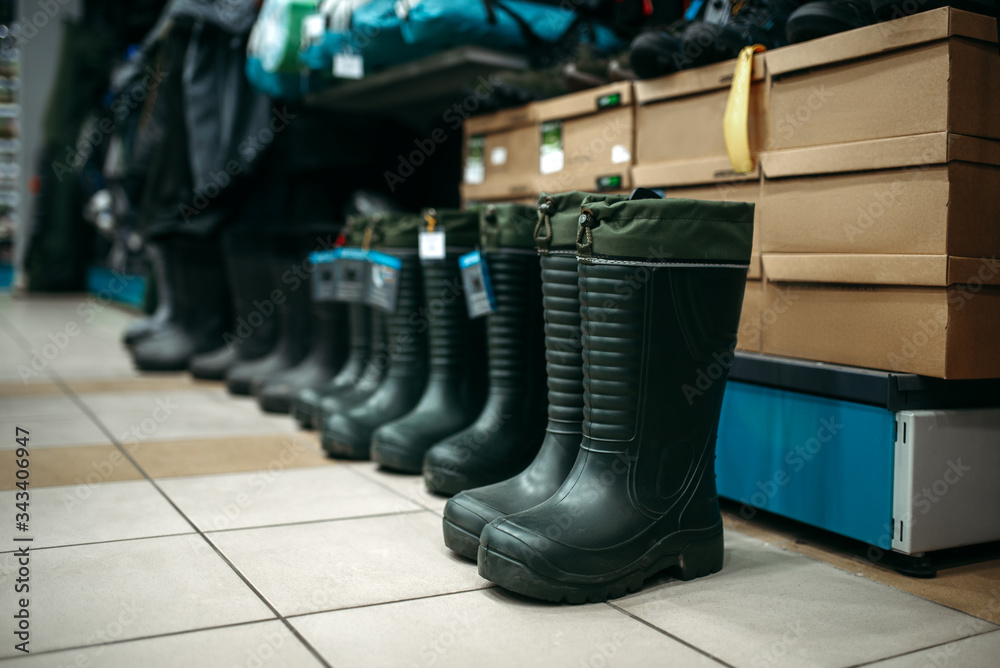 Row of rubber boots in fishing shop, nobody