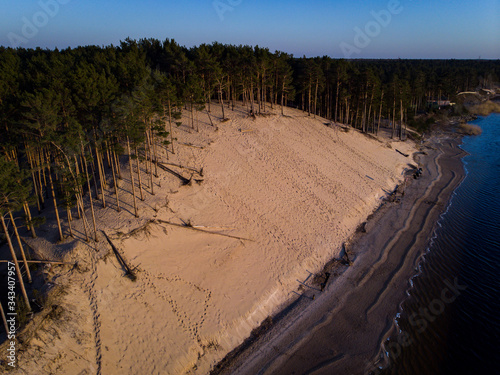 Riverside shore view of big white sand dune on a lovely evening sunset. photo