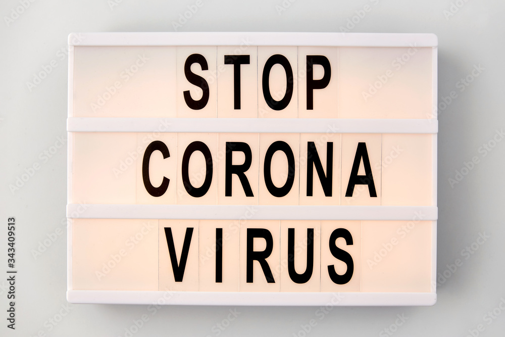 medicine, epidemic and healthcare concept - lightbox with stop coronavirus caution words on white background medicine, epidemic and healthcare concept - lightbox with stop coronavirus caution words on white background