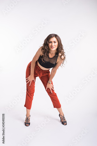Latina dance, strip dance, contemporary and bachata lady concept - Woman dancing improvisation and moving her long hair on a white background.