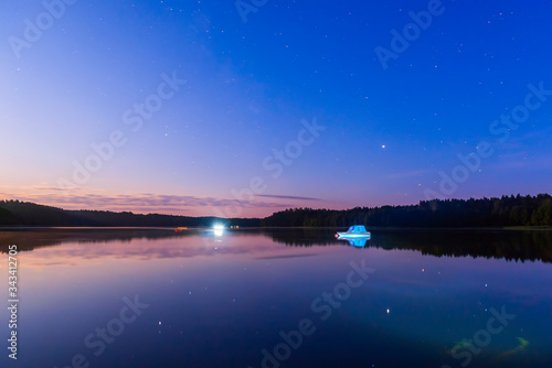 Beautiful night lake landscape. Calm lake like a mirror