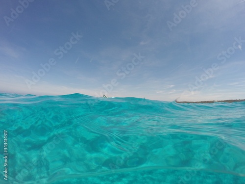Amazing blue sea with white sand underwater in Sardinia, Stintino, panorama background, ripple water surface with copy space