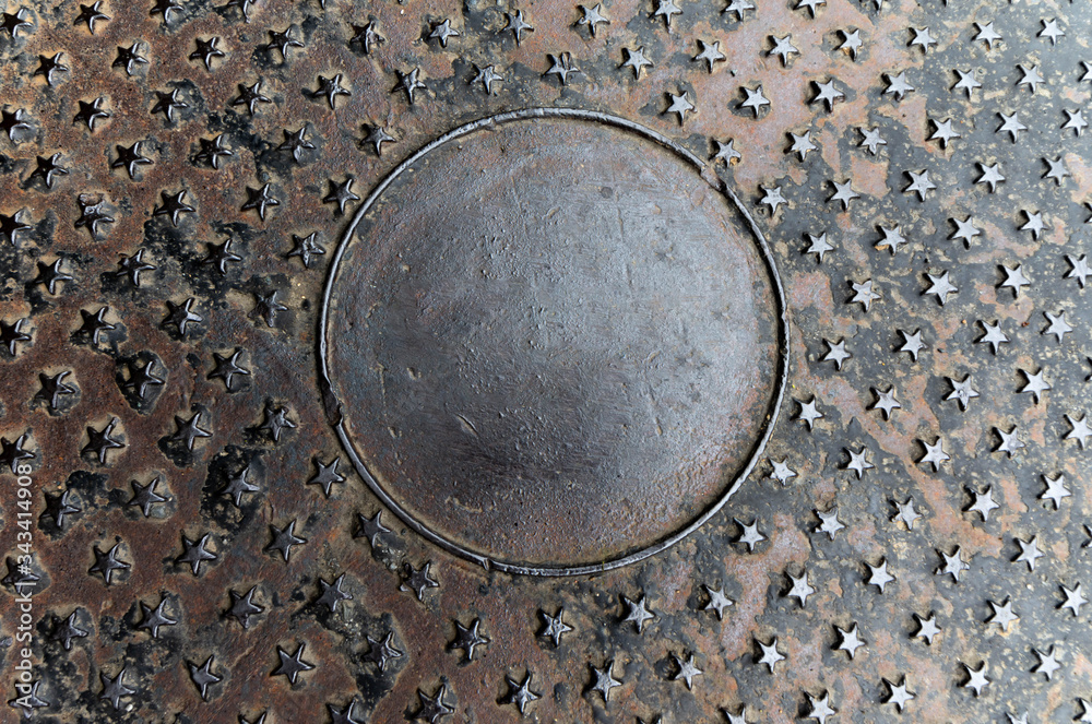 Manhole cover on street, drain cover top view Manhole cover on street, drain cover top view