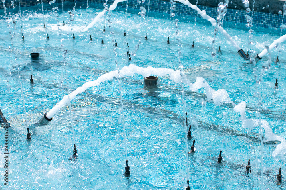 Splashing water in a blue pool