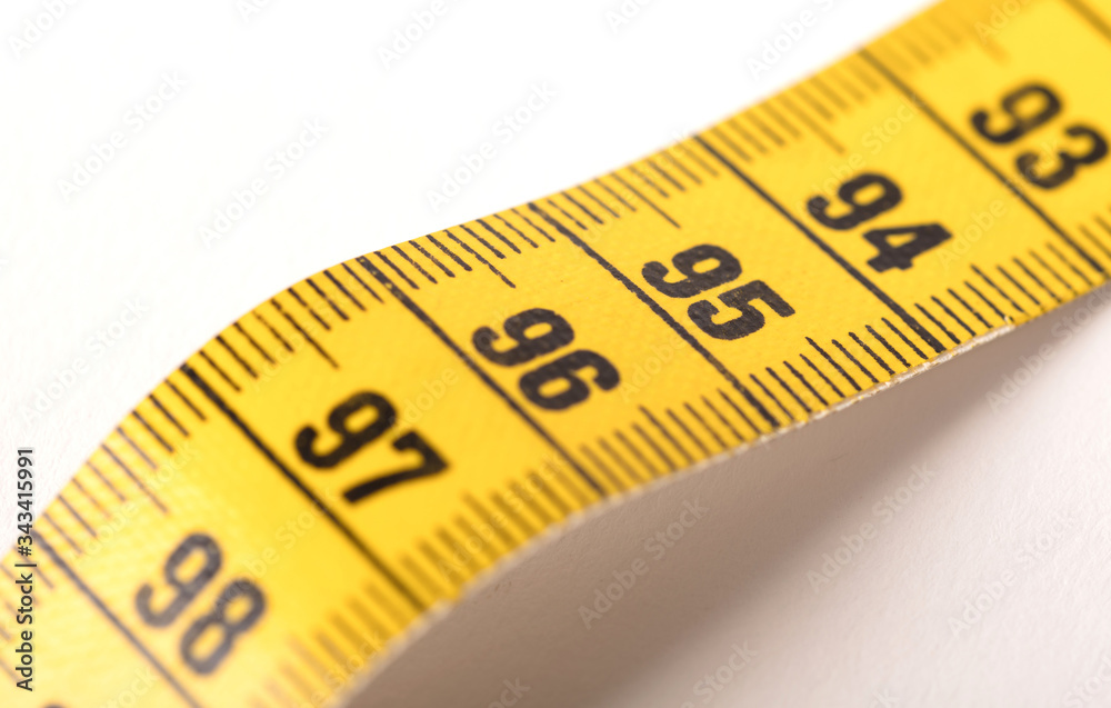 Close-up of a yellow measuring tape isolated on white - 95 Close-up of a yellow measuring tape isolated on white - 95