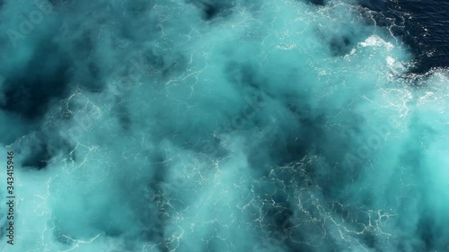 The ship's propellers create whirlpools of seawater and the magic of turquoise colors the water.