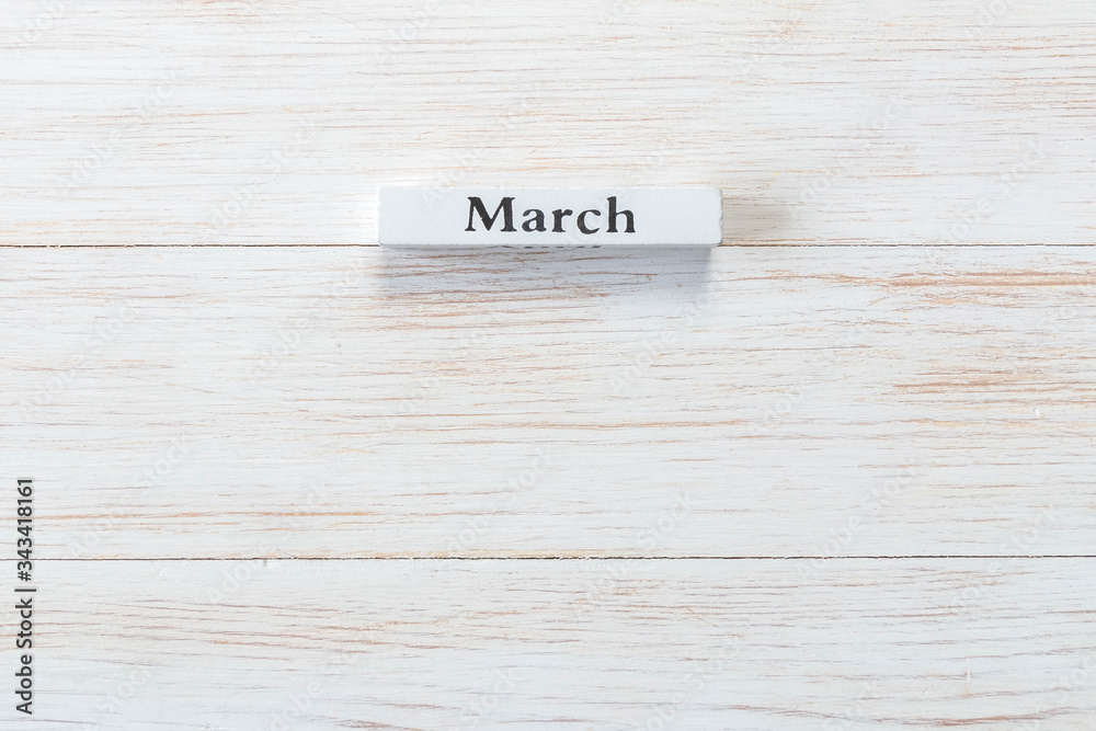 Wooden block of calendar with month March on wood background Wooden block of calendar with month March on wood background
