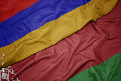 waving colorful flag of belarus and national flag of armenia.