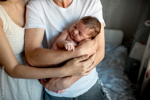 Newborn baby with mom and dad at home
