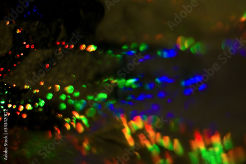 Dark abstract background with overflow  multicolored  rainbow bokeh and highlights.