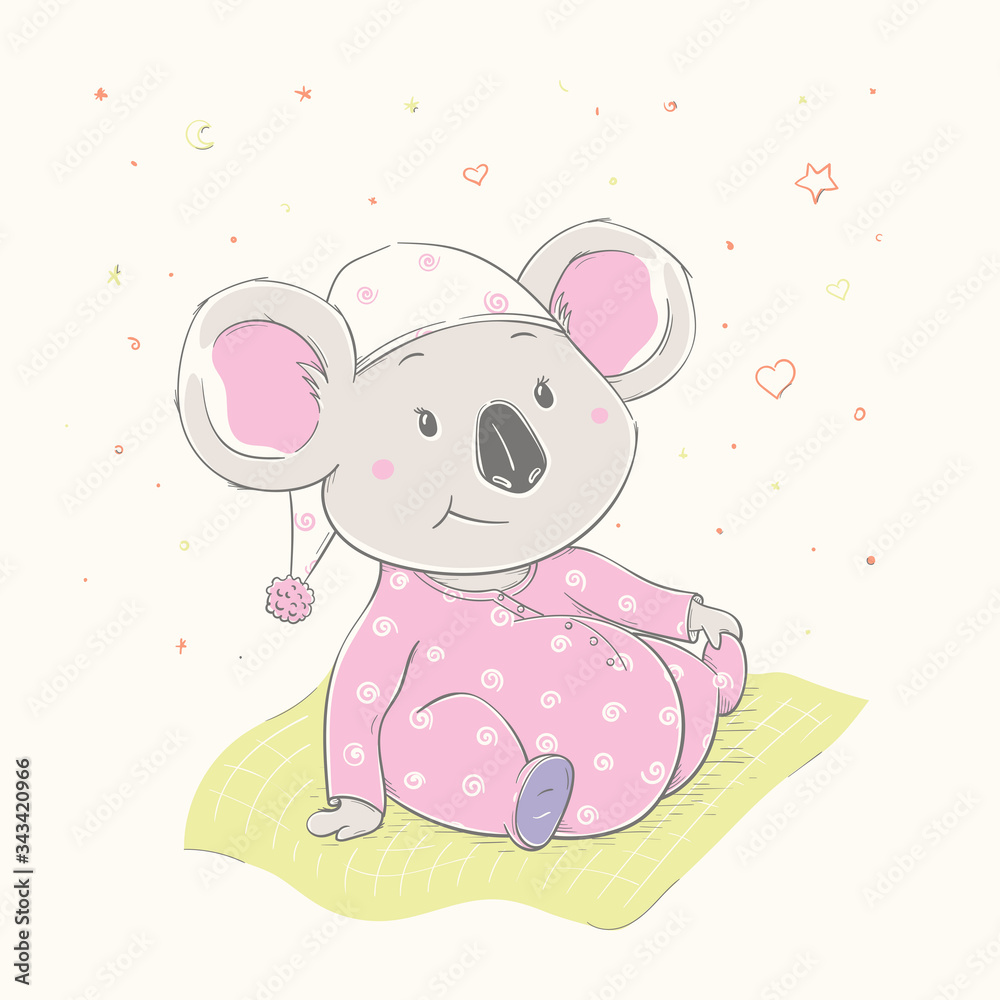 Fototapeta premium Lovely cute koala is sitting on the grass. Beautiful koala girl dressed in pink pajamas with hat.