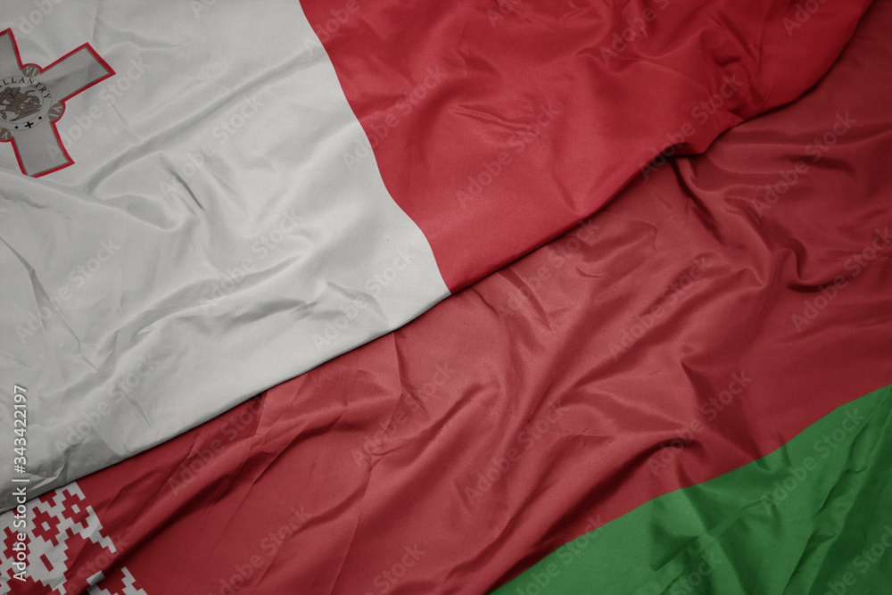 waving colorful flag of belarus and national flag of malta.